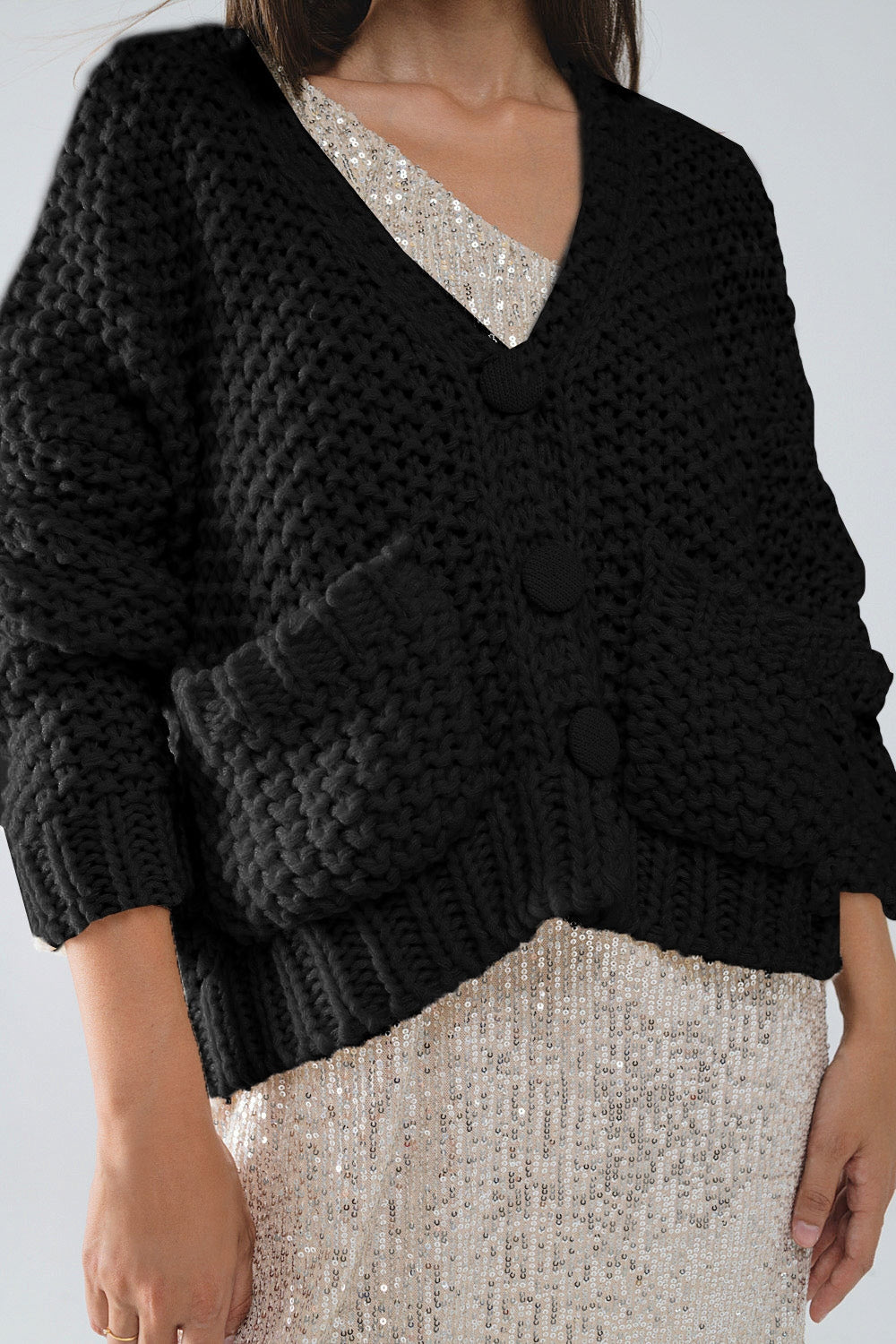 Chaqueta negra oversize de punto grueso con bolsillos