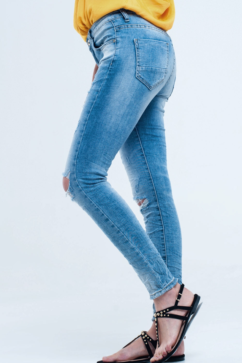 Jeans pitillo en lavado medio con rotos en las rodillas