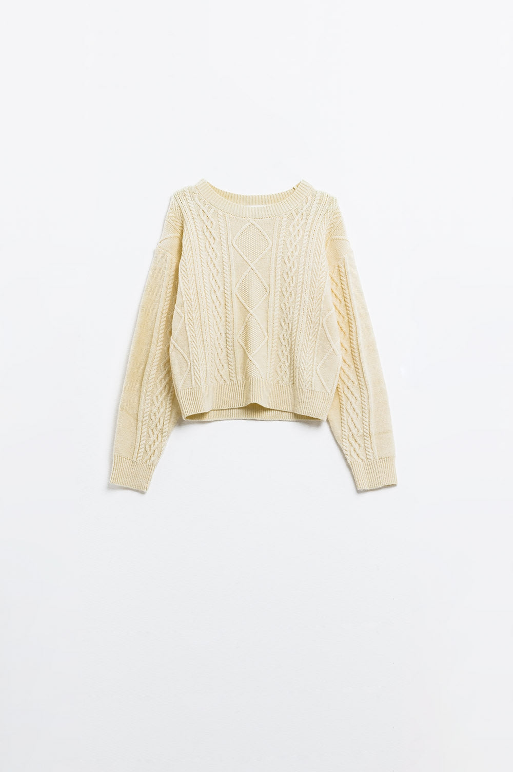 Jersey de punto suave color crema con diseño de cables