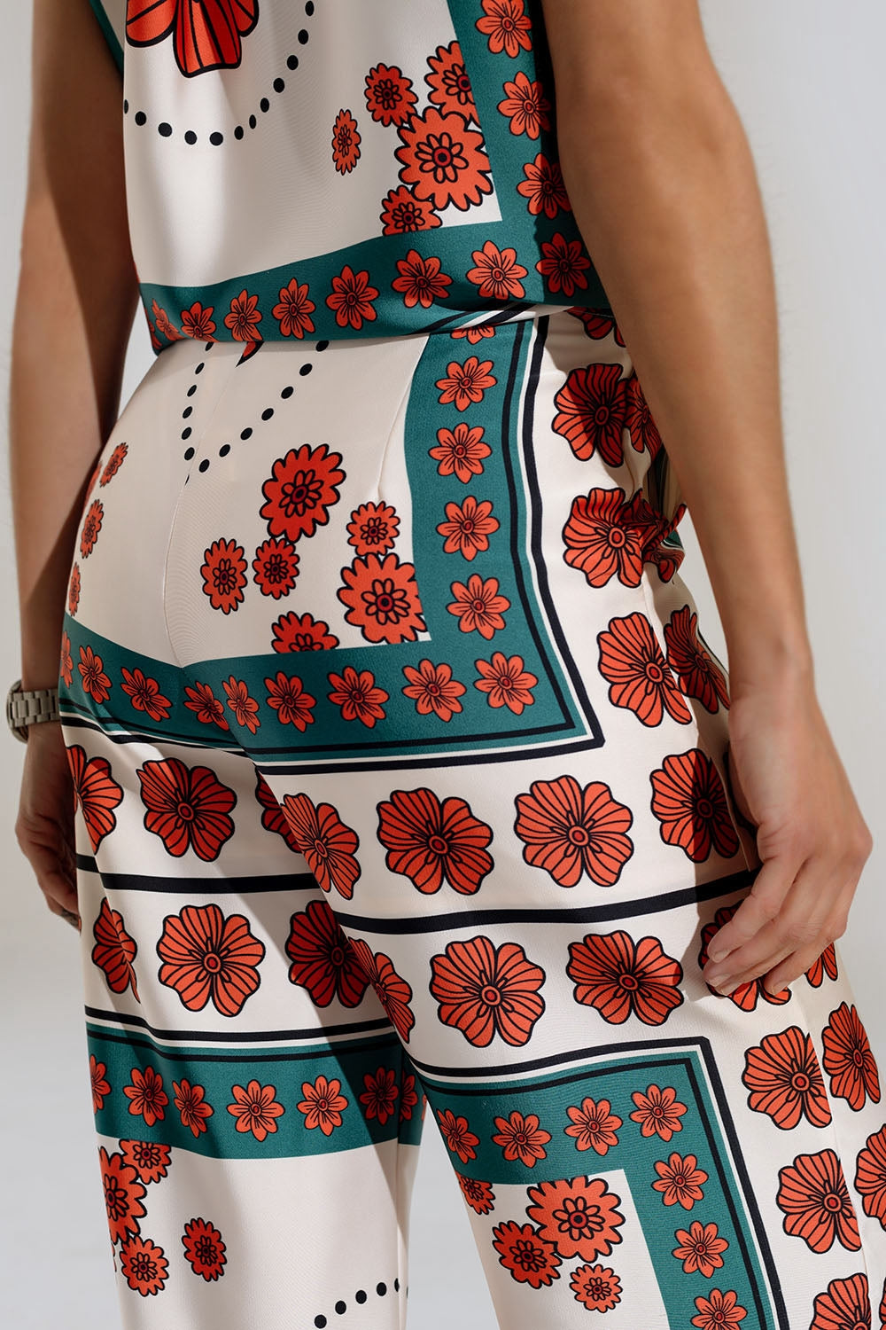 Pantalones de raso acampanados crema con diseño floral