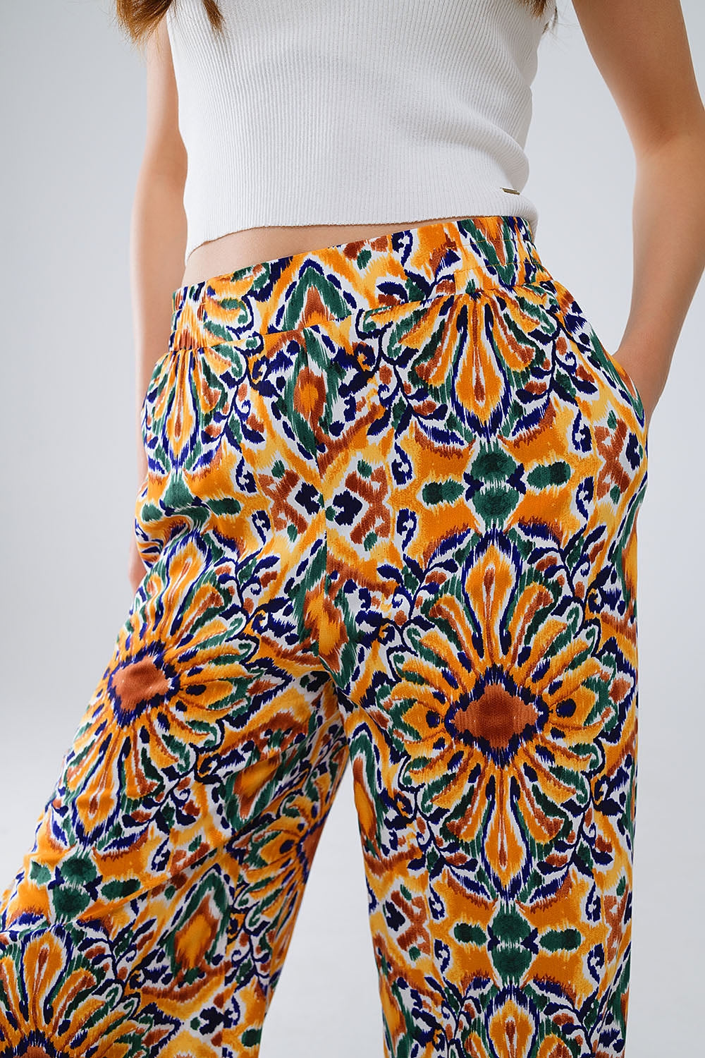Pantalones multicolores con estampado de flores en naranja y azul