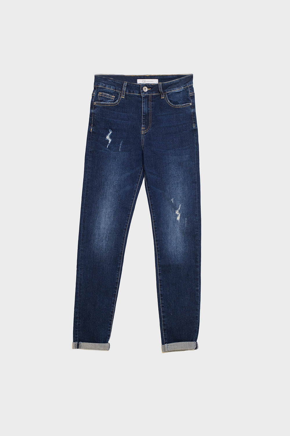 Vaqueros super ajustados desgastados en denim elástico con lavado oscuro