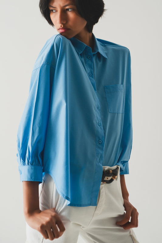Q2 Camisa azul con mangas voluminosas de popelina