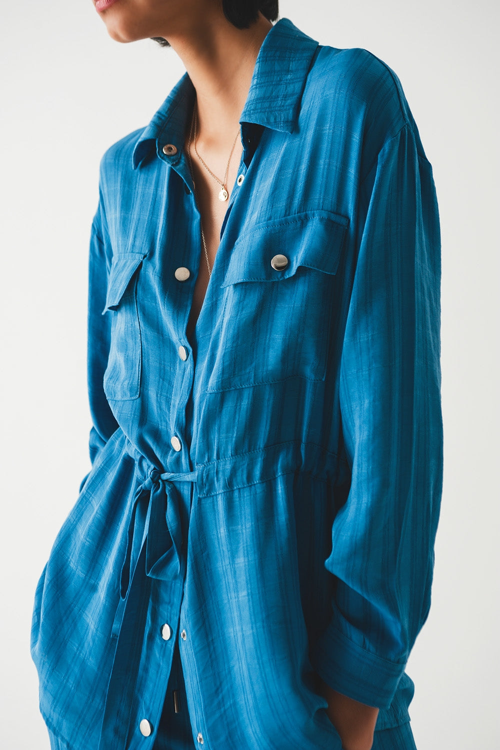 Camisa azul de manga larga con lazada en la cintura