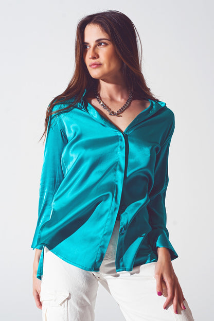 Camisa de saten turquesa con abertura en los puños