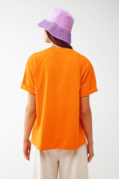 Camiseta con el texto Good Vibes en naranja