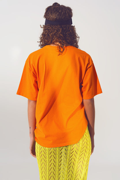 Camiseta con texto Good Vibes en naranja