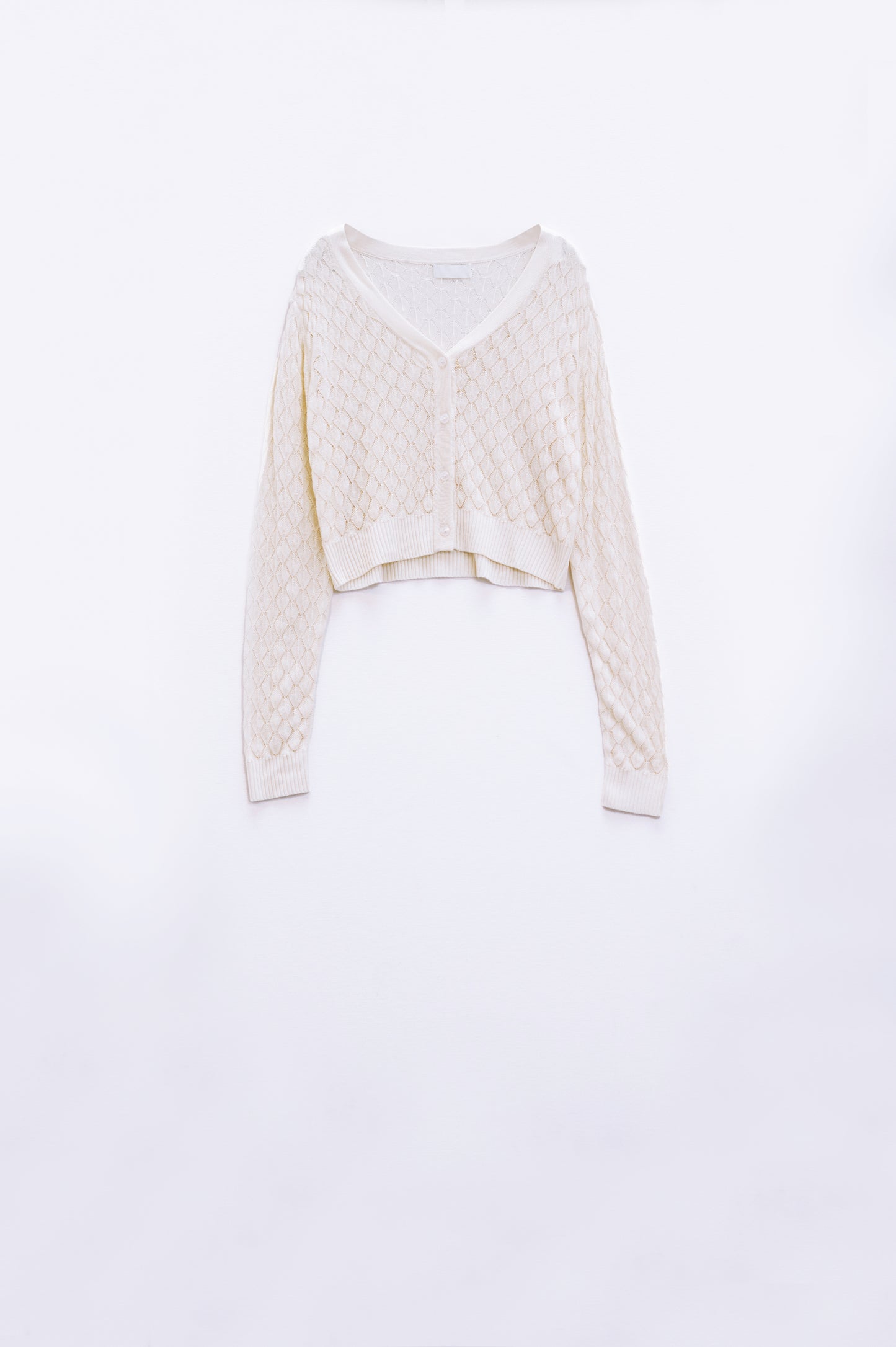 Cárdigan corto beige con estampado de rombos