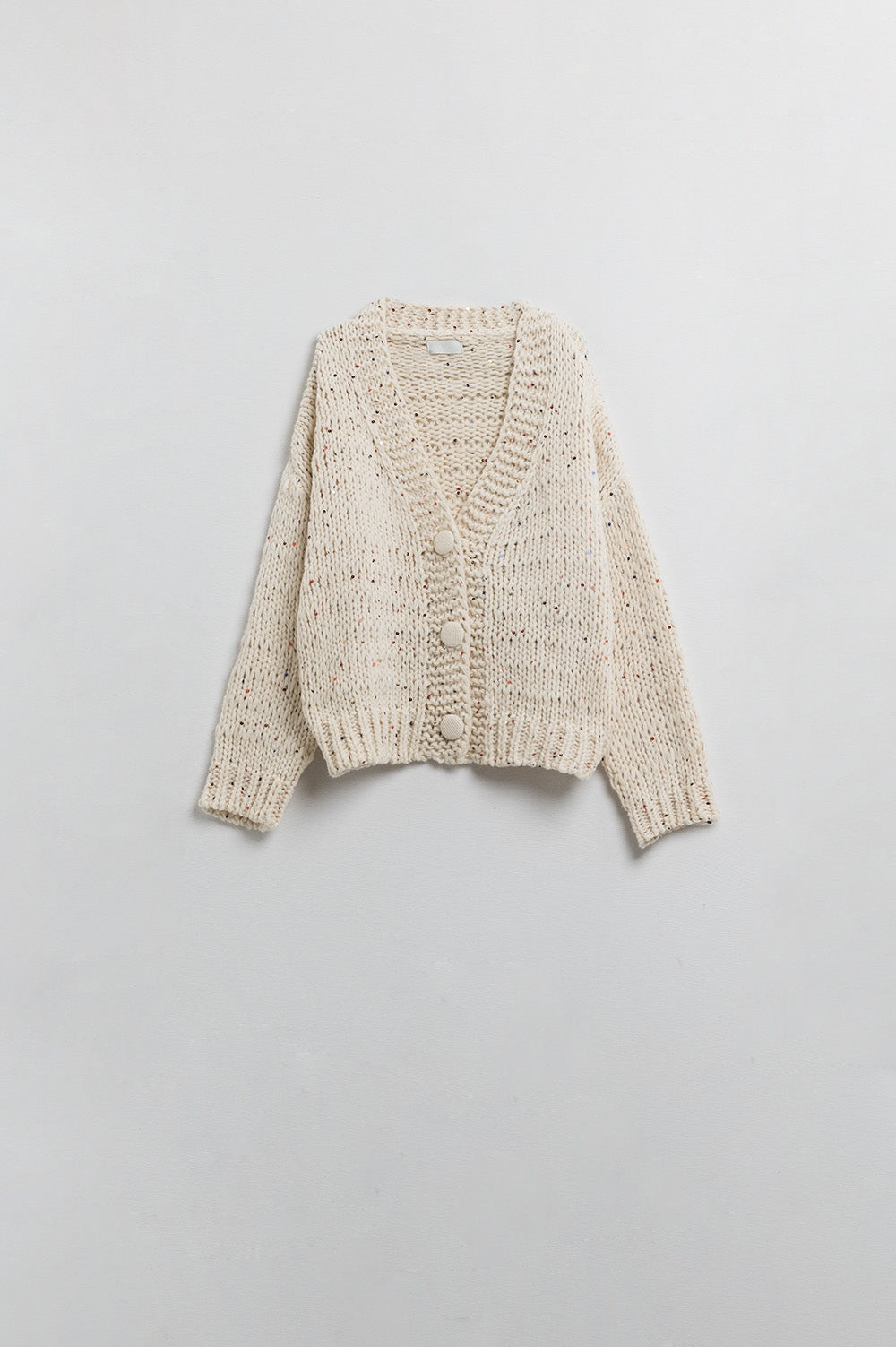 Chaqueta oversize de punto grueso en color crema con detalle de lentejuelas