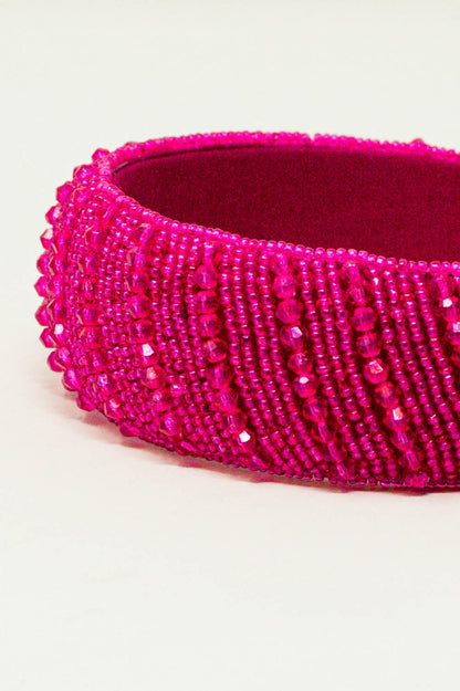 Diadema con cuentas en fucsia