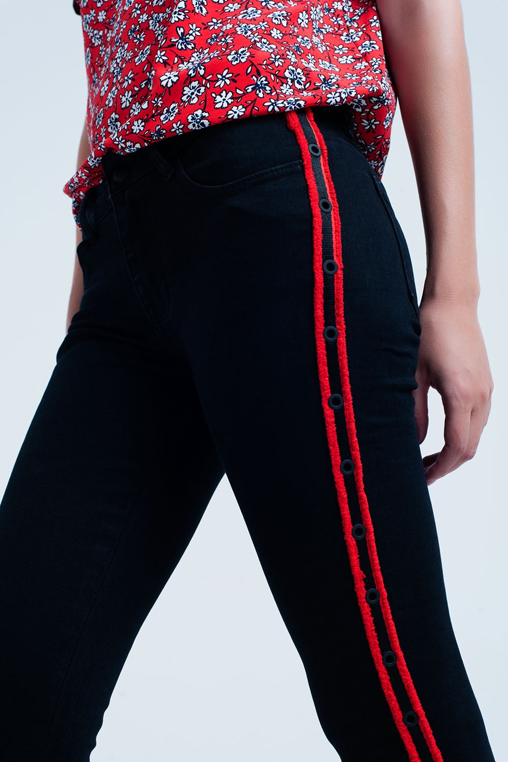 Jeans negro super skinny con ojales laterales