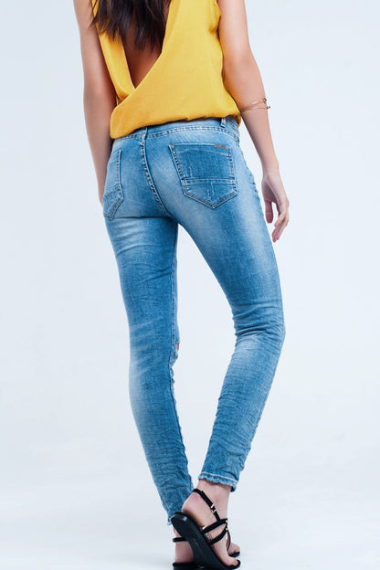 Jeans pitillo en lavado medio con rotos en las rodillas