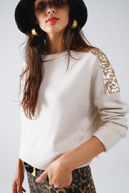 Jersey beige de manga larga con lentejuelas en los hombros