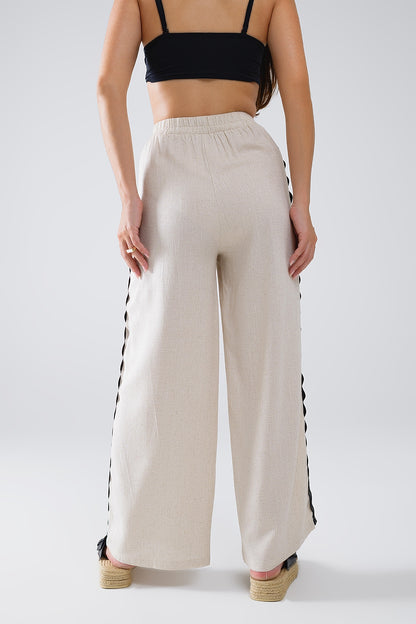 Pantalón de lino con festón en contraste beige