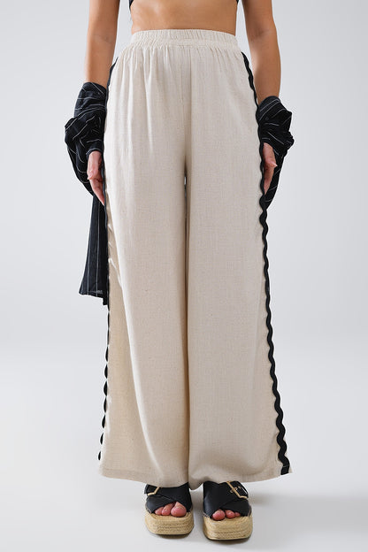 Pantalón de lino con festón en contraste beige
