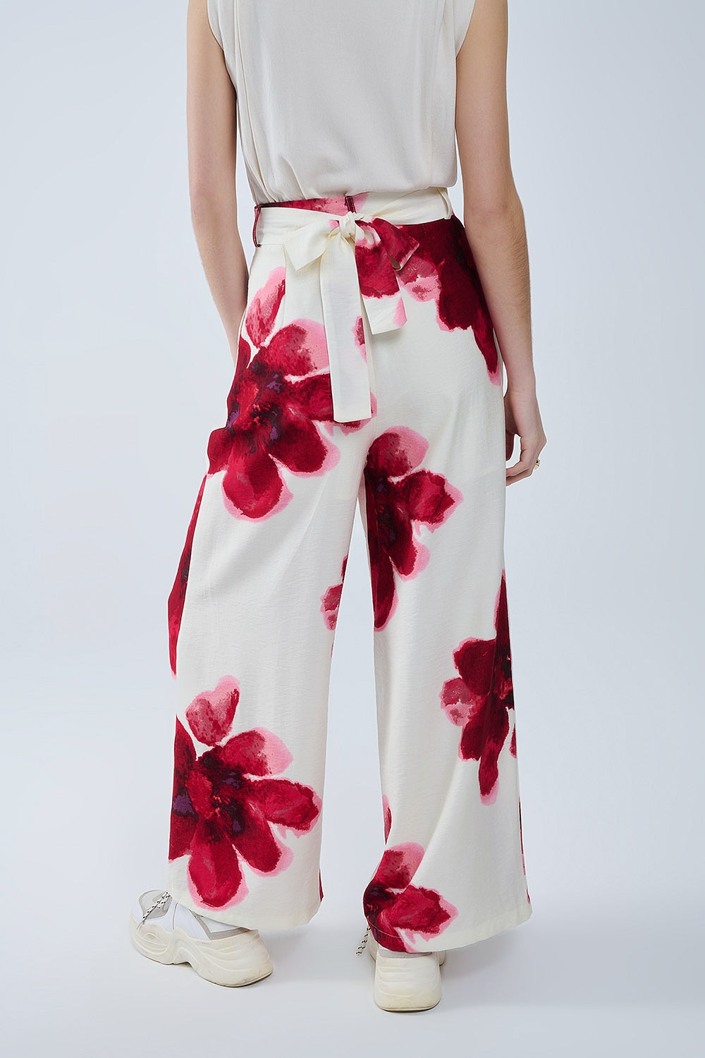 Pantalón palazzo beige con estampado de flores tropicales rojas y cinturón a juego