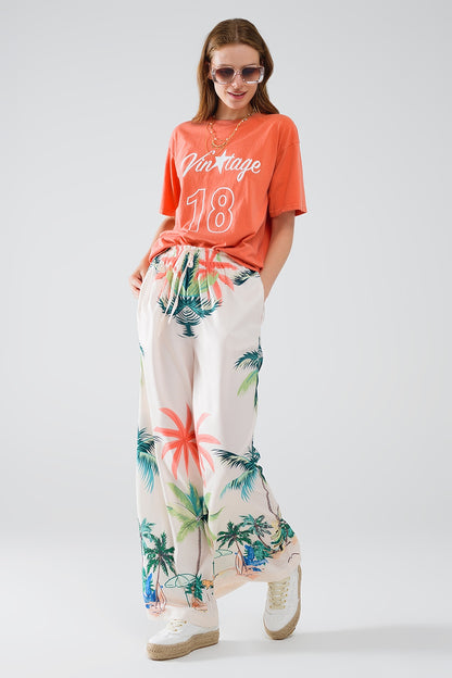 Pantalón recto crema con estampado playero y cintura elástica