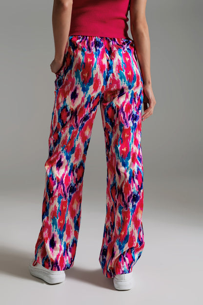 Pantalones estilo palazzo con estampado abstracto en rosa y azul