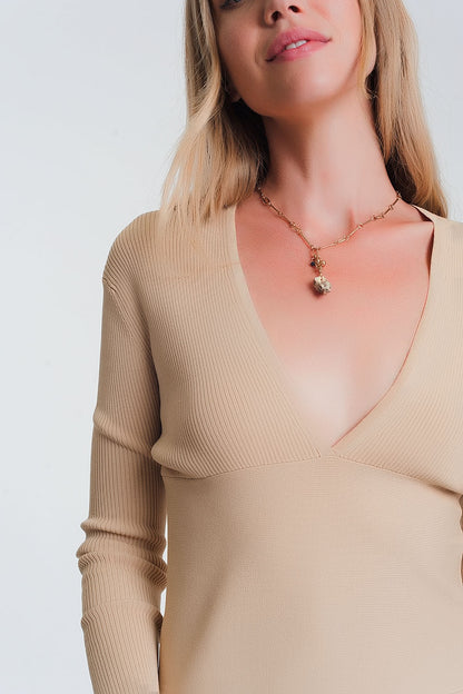 Sueter de canale en beige de cuello pico