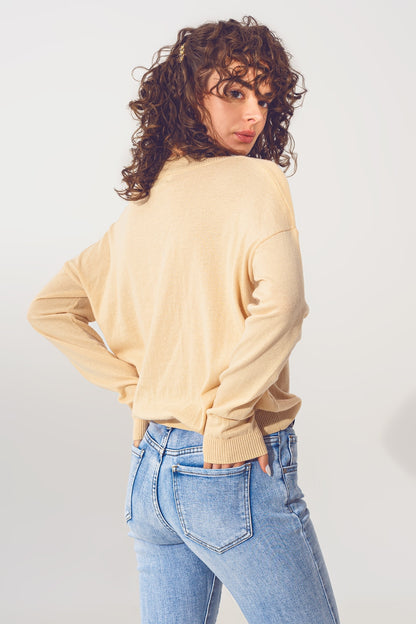 Sueter de punto fino en beige de pico amplio