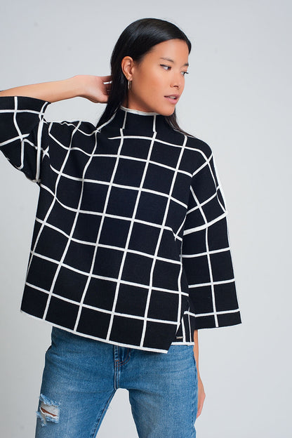 Suéter negro 3/4 con estampado de cuadros detalle en la manga y cuello alto