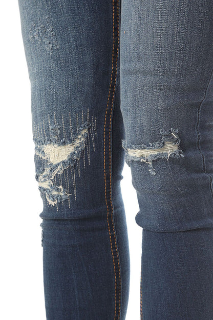 Vaqueros pitillo de talle alto con detalles desgastados