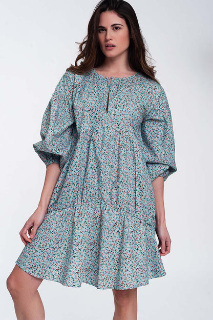 Vestido corto turquesa amplio con bajo con volante mangas abullonadas y flores